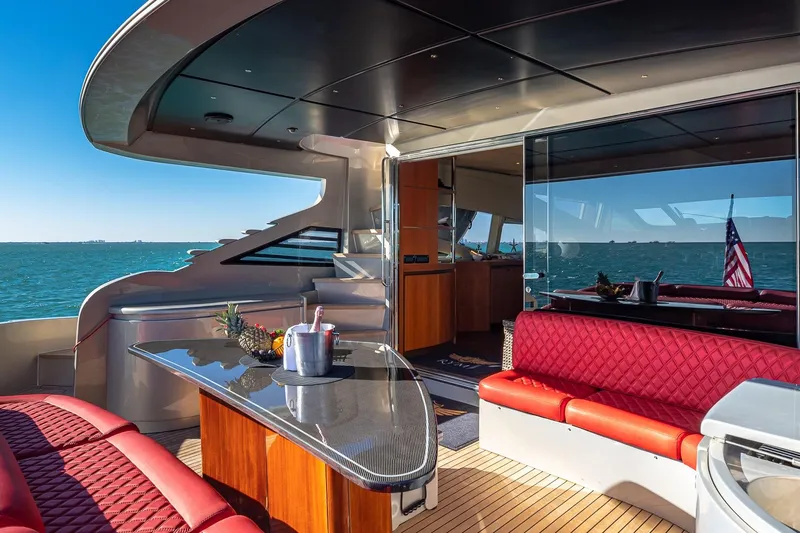 Regal Yacht Photos Pics Luxurious 2008 Pershing 90 yacht interior with red seating, ocean view, and elegant design.