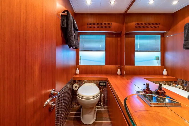 Regal Yacht Photos Pics Luxurious 2008 Pershing 90 yacht bathroom with wood accents and modern fixtures.