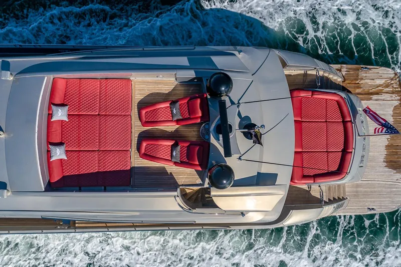 Regal Yacht Photos Pics Aerial view of 2008 Pershing 90 yacht with red seating and ocean waves.