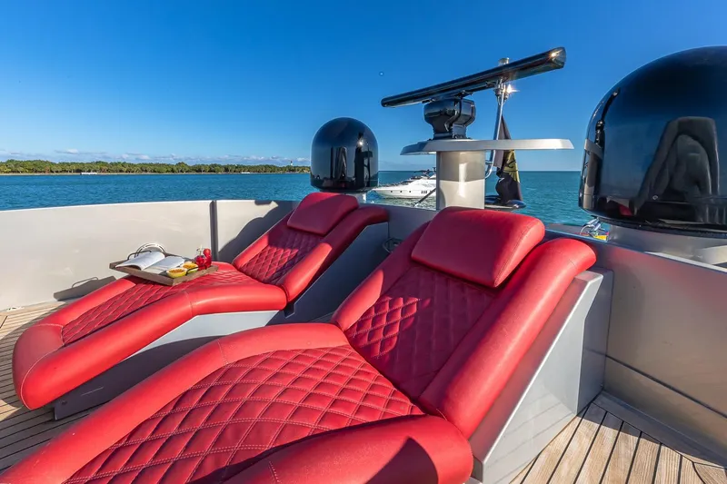 Regal Yacht Photos Pics Luxurious red loungers on 2008 Pershing 90 yacht deck, overlooking serene blue waters.