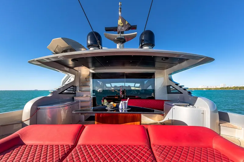 Regal Yacht Photos Pics Luxurious 2008 Pershing 90 yacht with red seating, cruising on clear blue waters.