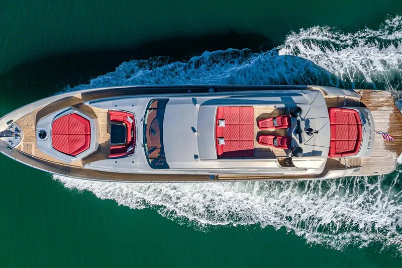 Regal Yacht Photos Pics Aerial view of 2008 Pershing 90 yacht cruising on water with red seating.