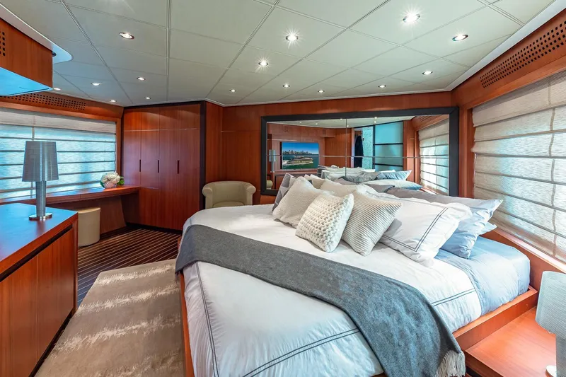 Regal Yacht Photos Pics Luxurious 2008 Pershing 90 yacht bedroom with elegant wood paneling and plush bedding.