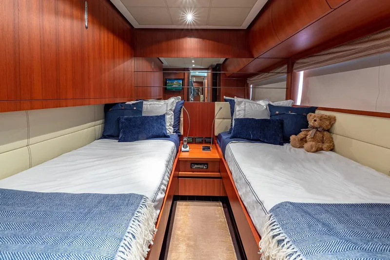 Regal Yacht Photos Pics Luxurious 2008 Pershing 90 yacht cabin with twin beds and plush decor.