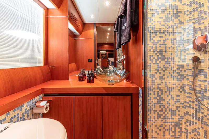 Regal Yacht Photos Pics Luxurious bathroom on 2008 Pershing 90 yacht with wood accents and mosaic tiles.
