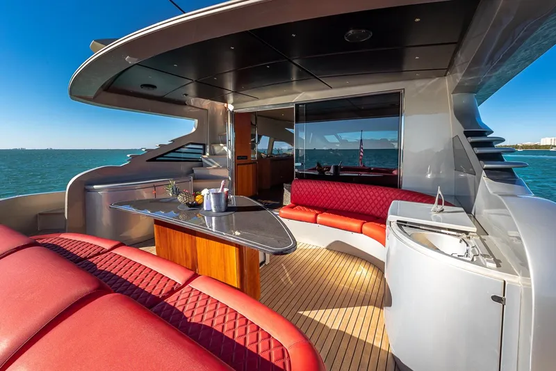 Regal Yacht Photos Pics Luxurious 2008 Pershing 90 yacht deck with red seating and ocean view.