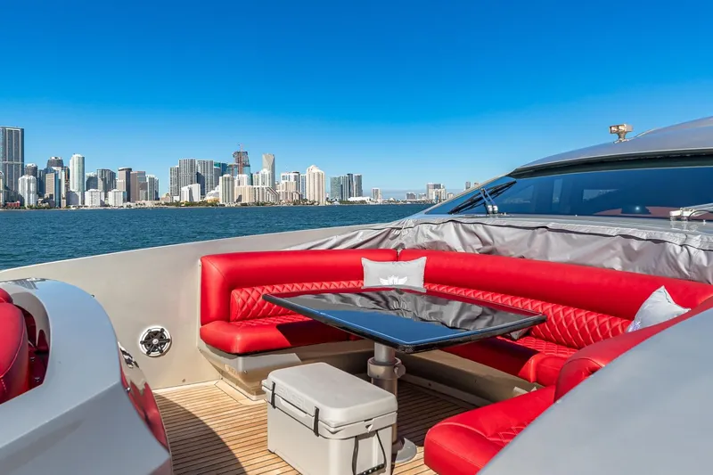 Regal Yacht Photos Pics Luxurious 2008 Pershing 90 yacht with red seating, city skyline view, and blue sky.