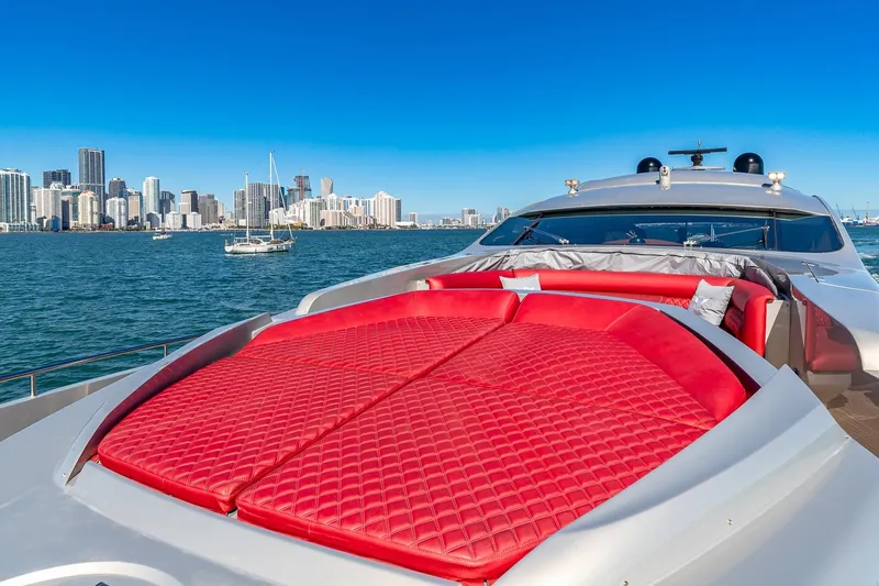 Regal Yacht Photos Pics Luxury Pershing 90 yacht with red sunbed, city skyline in background, 2008 model.
