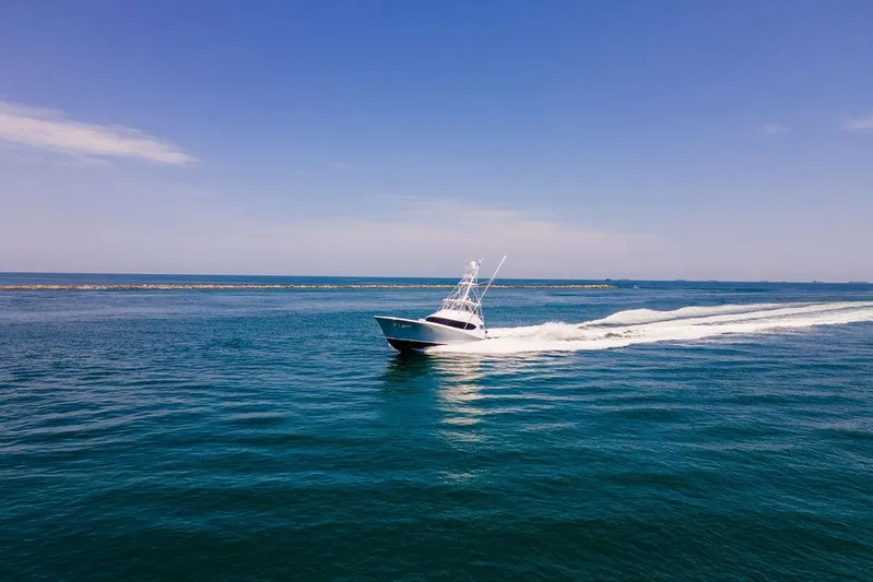 Sashimi Yacht Photos Pics Hatteras 63 GT 2014 yacht cruising on open blue sea under clear sky.