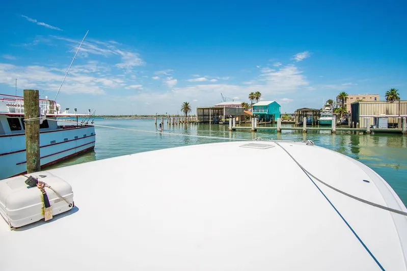 Sashimi Yacht Photos Pics Bow view of 2014 Hatteras 63 GT yacht docked in sunny marina.