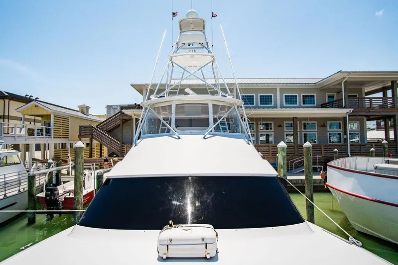 Sashimi Yacht Photos Pics 2014 Hatteras 63 GT yacht docked at marina under clear blue sky.