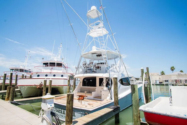 Sashimi Yacht Photos Pics 2014 Hatteras 63 GT yacht docked at marina under clear blue sky.