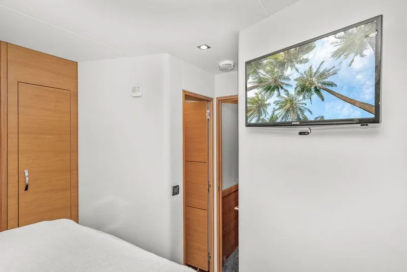 Sashimi Yacht Photos Pics Interior of 2014 Hatteras 63 GT yacht with wall-mounted TV and wooden accents.