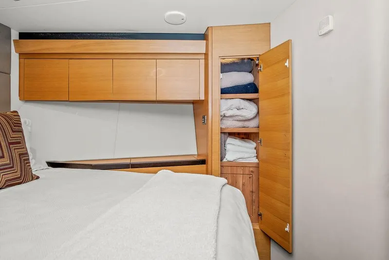 Sashimi Yacht Photos Pics Interior of 2014 Hatteras 63 GT yacht with wooden cabinetry and open closet.