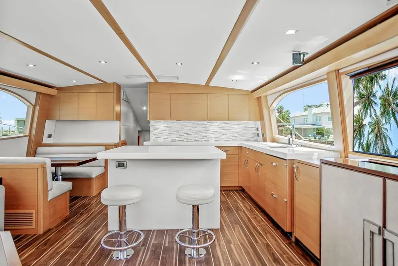 Sashimi Yacht Photos Pics Luxurious interior of 2014 Hatteras 63 GT yacht with modern kitchen and seating area.