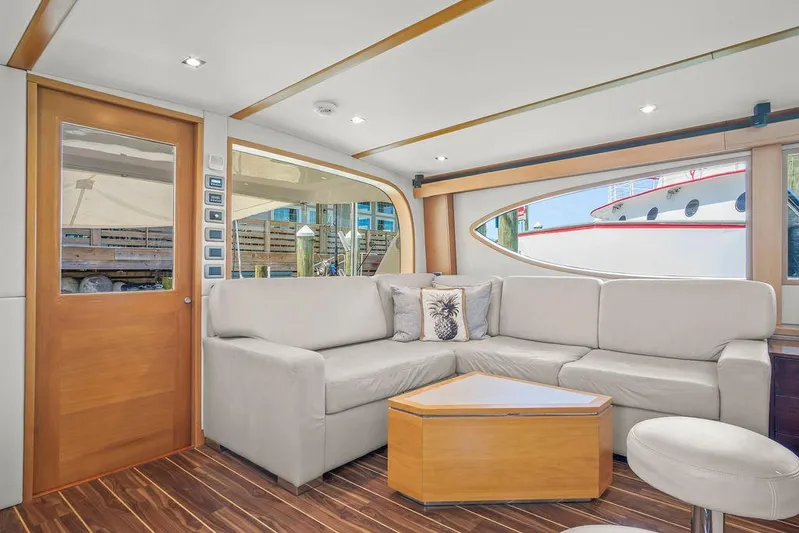 Sashimi Yacht Photos Pics Luxurious interior of 2014 Hatteras 63 GT yacht with modern seating and wooden accents.