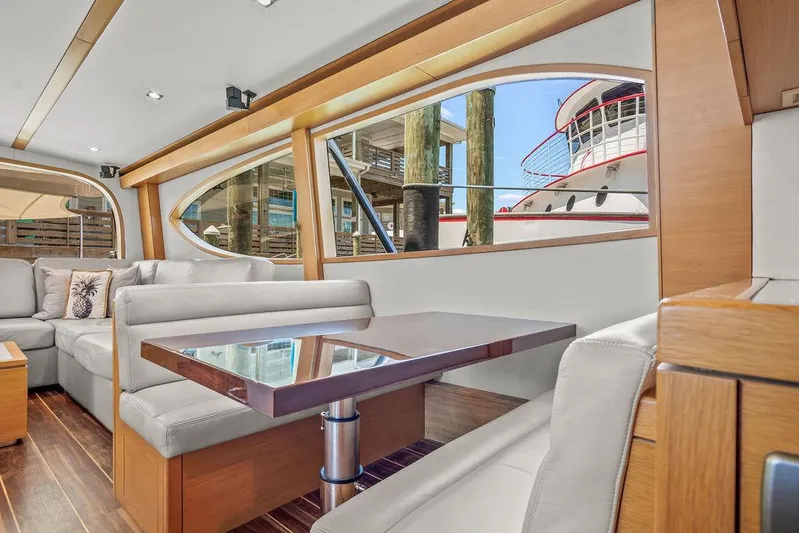 Sashimi Yacht Photos Pics Luxurious interior of 2014 Hatteras 63 GT yacht with modern seating and large windows.