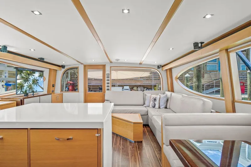 Sashimi Yacht Photos Pics Luxurious interior of 2014 Hatteras 63 GT yacht with modern furnishings and large windows.