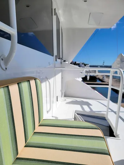 Prime Time Yacht Photos Pics 2002 Viking Enclosed Bridge yacht with striped seating and marina view.