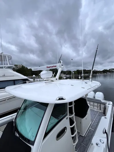  Yacht Photos Pics 2018 Boston Whaler 350 Outrage boat docked under cloudy skies.