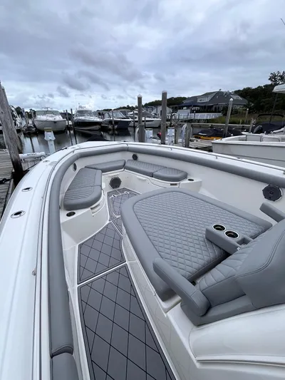  Yacht Photos Pics 2018 Boston Whaler 350 Outrage boat with gray seating, docked at a marina.