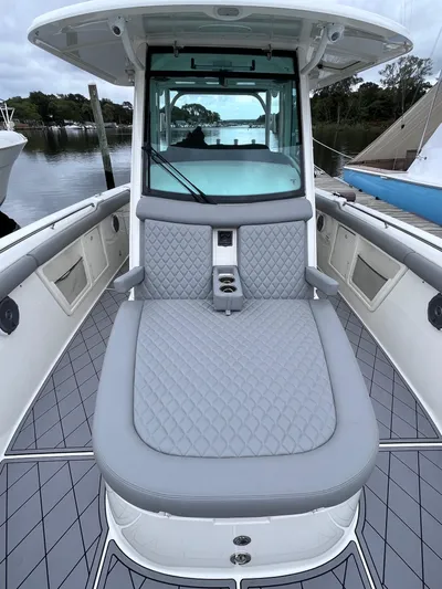  Yacht Photos Pics 2018 Boston Whaler 350 Outrage boat with cushioned seating and sleek design.