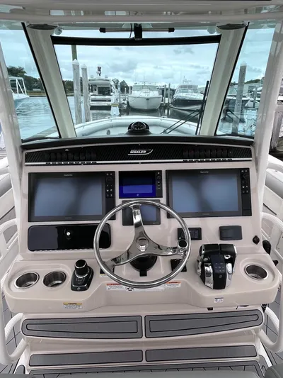  Yacht Photos Pics 2018 Boston Whaler 350 Outrage helm with dual screens and steering wheel.