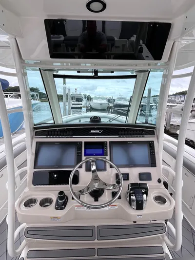  Yacht Photos Pics 2018 Boston Whaler 350 Outrage helm with advanced navigation controls and panoramic marina view.