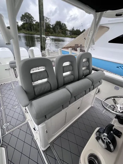  Yacht Photos Pics 2018 Boston Whaler 350 Outrage boat interior with gray seating and modern helm.