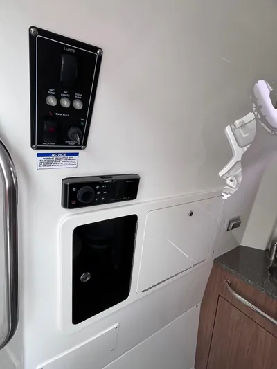  Yacht Photos Pics Control panel and storage area inside 2018 Boston Whaler 350 Outrage boat.