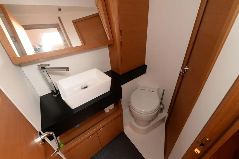  Yacht Photos Pics Modern bathroom in 2019 Grand Soleil 48 Performance yacht, featuring sleek sink and toilet.