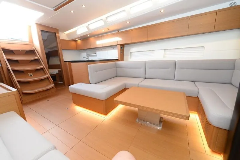  Yacht Photos Pics Luxurious interior of 2019 Grand Soleil 48 Performance yacht with modern seating and wooden finishes.
