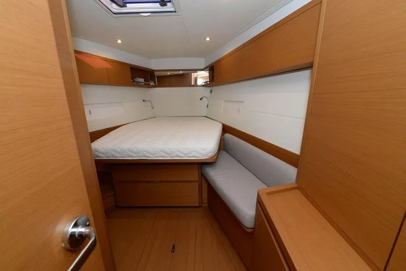  Yacht Photos Pics 2019 Grand Soleil 48 Performance yacht cabin with wooden interior and cozy bed.