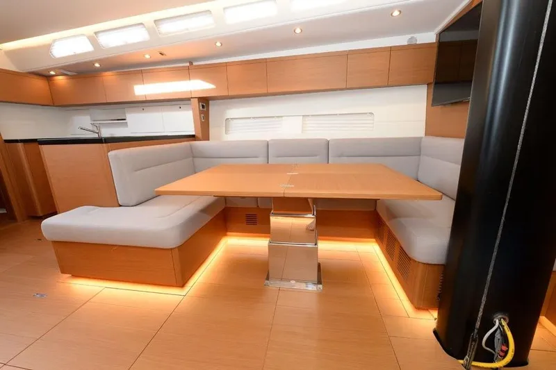  Yacht Photos Pics Luxurious interior of 2019 Grand Soleil 48 Performance yacht with modern dining area.