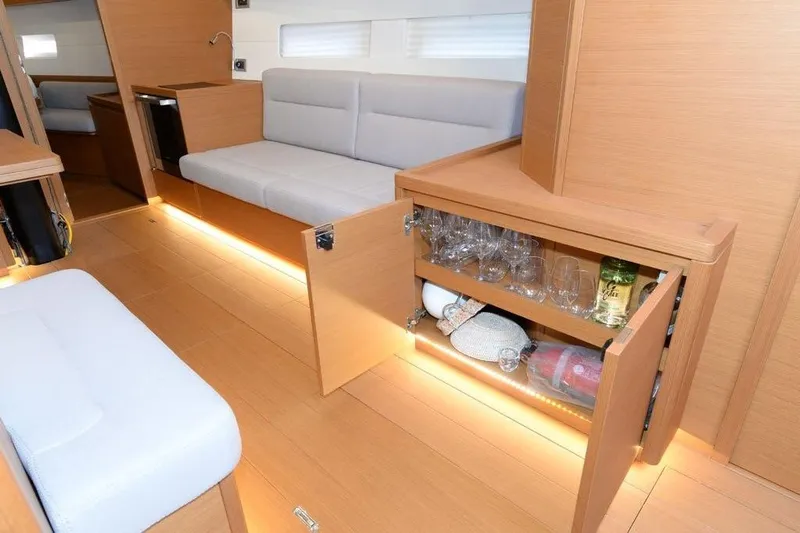  Yacht Photos Pics Luxurious interior of 2019 Grand Soleil 48 Performance yacht with elegant wood finish and seating.