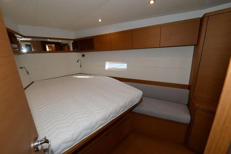  Yacht Photos Pics Luxurious cabin interior of 2019 Grand Soleil 48 Performance yacht with cozy bed and seating.