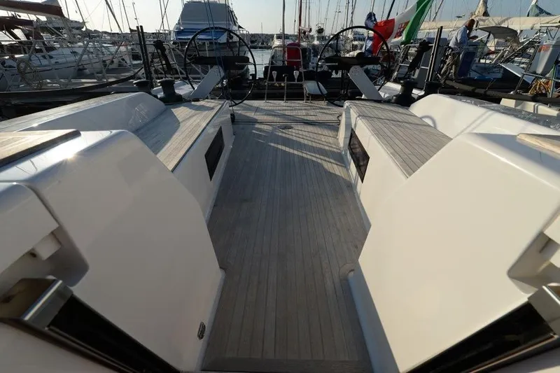  Yacht Photos Pics 2019 Grand Soleil 48 Performance yacht deck with dual steering wheels in marina.