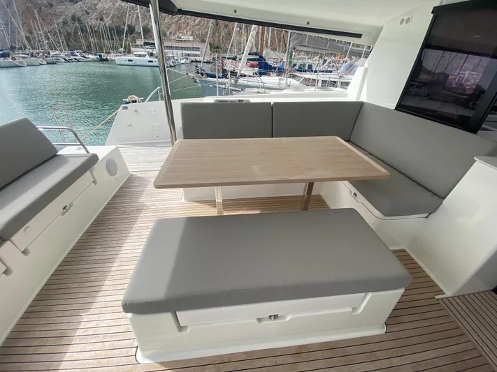 Luna Yacht Photos Pics Spacious seating area on 2020 Fountaine Pajot Saona 47 catamaran with marina view.