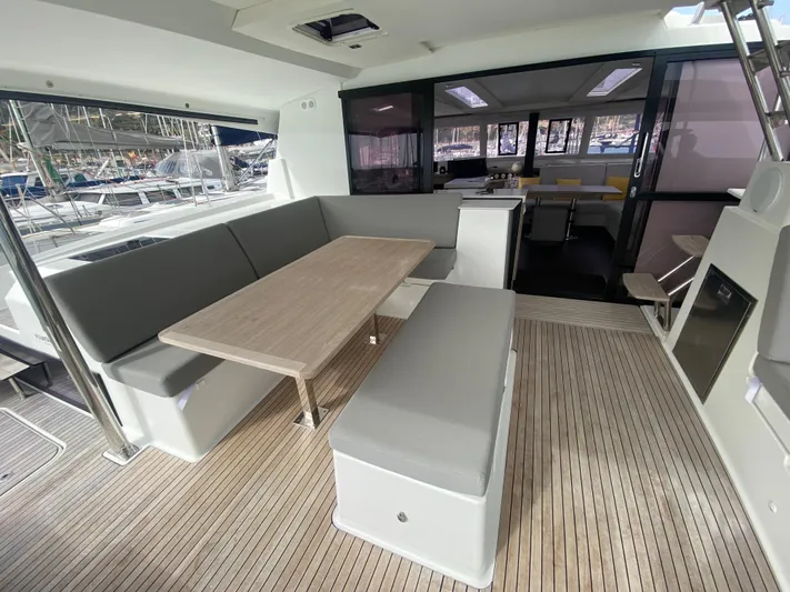 Luna Yacht Photos Pics Spacious deck area of 2020 Fountaine Pajot Saona 47 catamaran with seating and table.