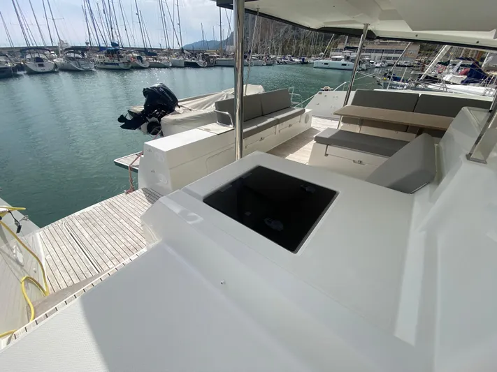 Luna Yacht Photos Pics Spacious deck of 2020 Fountaine Pajot Saona 47 catamaran in marina setting.