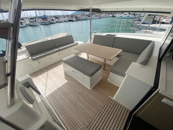 Luna Yacht Photos Pics Spacious deck of 2020 Fountaine Pajot Saona 47 catamaran with seating and table.