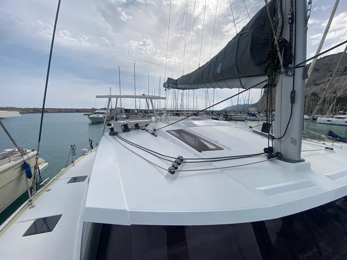 Luna Yacht Photos Pics 2020 Fountaine Pajot Saona 47 catamaran docked at marina, showcasing sleek deck design.