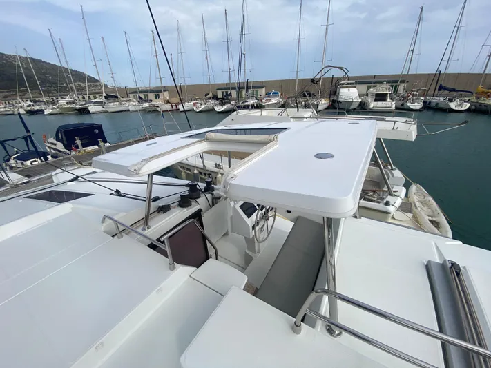Luna Yacht Photos Pics Fountaine Pajot Saona 47 catamaran, 2020 model, docked in a marina with multiple sailboats.