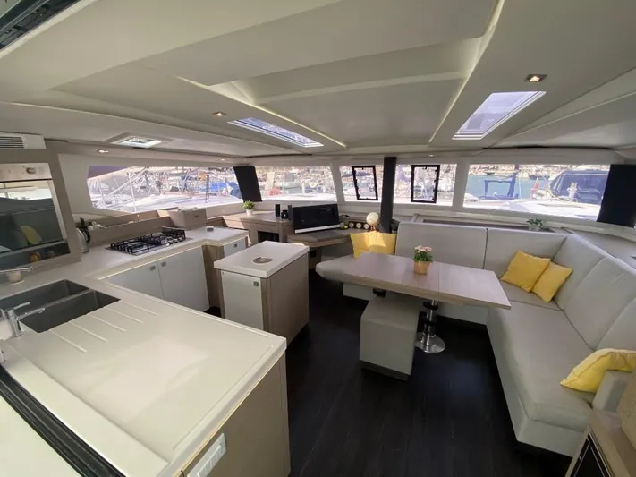 Luna Yacht Photos Pics Luxurious interior of 2020 Fountaine Pajot Saona 47 catamaran with modern kitchen and seating area.