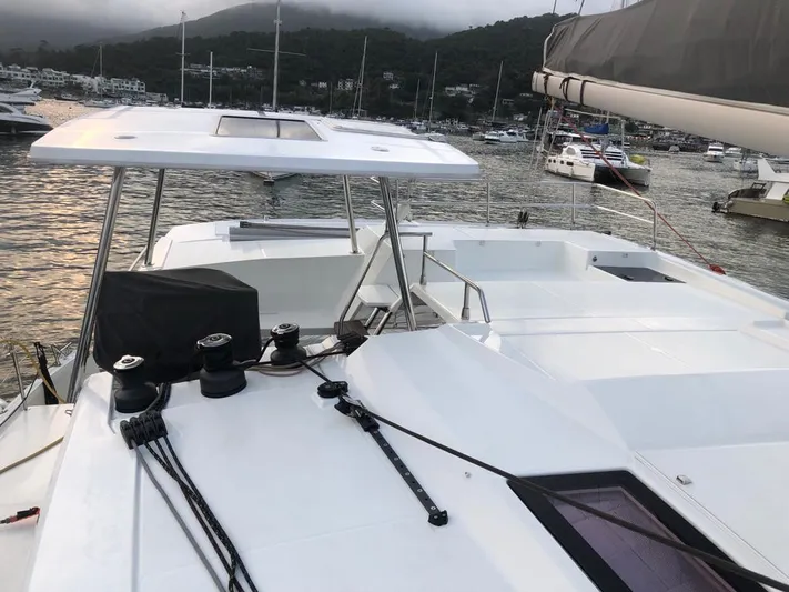 Luna Yacht Photos Pics 2020 Fountaine Pajot Saona 47 catamaran docked in a scenic marina.