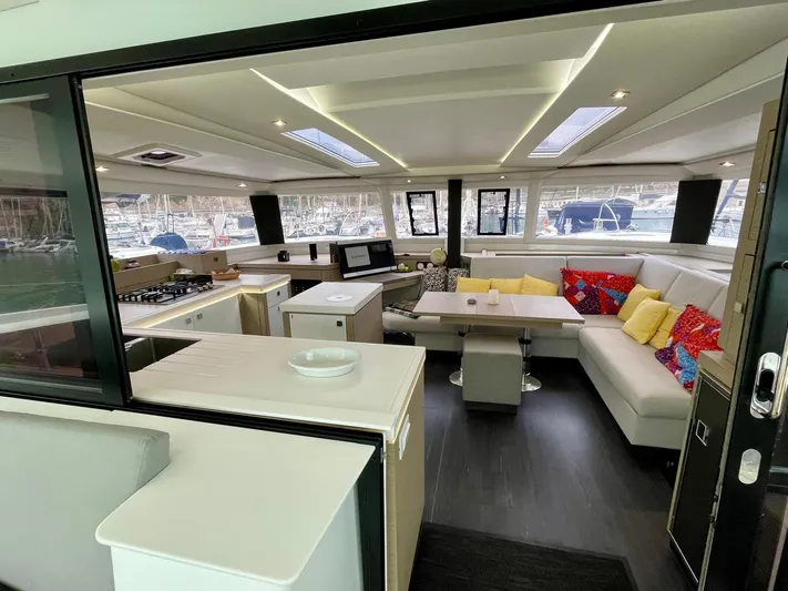 Luna Yacht Photos Pics Luxurious interior of 2020 Fountaine Pajot Saona 47 catamaran with modern kitchen and cozy seating area.