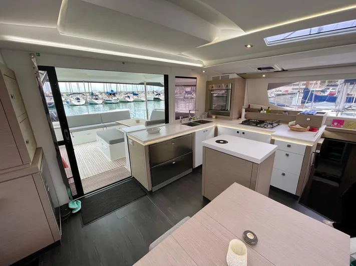Luna Yacht Photos Pics Modern interior of 2020 Fountaine Pajot Saona 47 catamaran with spacious kitchen and marina view.