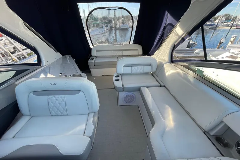 Then Again Yacht Photos Pics Luxurious interior of a 2021 Regal 33 XO yacht with elegant seating and marina view.