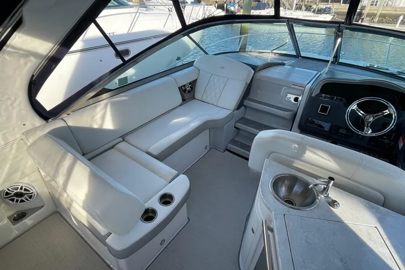 Then Again Yacht Photos Pics Luxurious interior of 2021 Regal 33 XO boat with seating and helm.