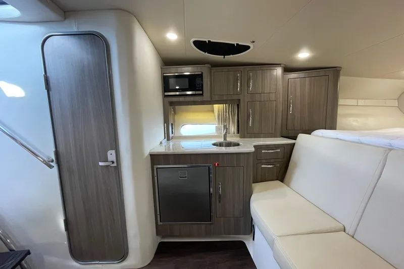 Then Again Yacht Photos Pics 2021 Regal 33 XO yacht interior with modern kitchenette and seating area.